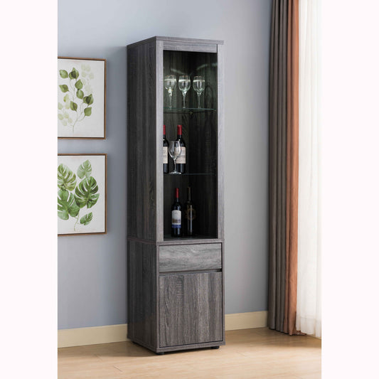 A Modern Wine Showcasing Cabinet with two glass shelves and a storage cabinet stands against a light gray wall by framed leaf artwork and a large window with white and brown curtains, displaying wine bottles and glasses.