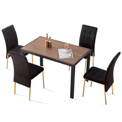 A 5-piece dining set features a creative rectangular table and four Nordic velvet high-back chairs with golden legs. On the table sit two condiment bottles, a glass, and an open magazine.