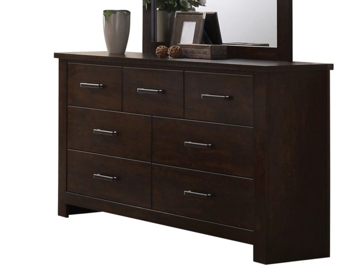 The Panang Mahogany Dresser features six drawers with metal handles, topped with a silver vase, framed photo, decorative accents, and set against a large mirror.