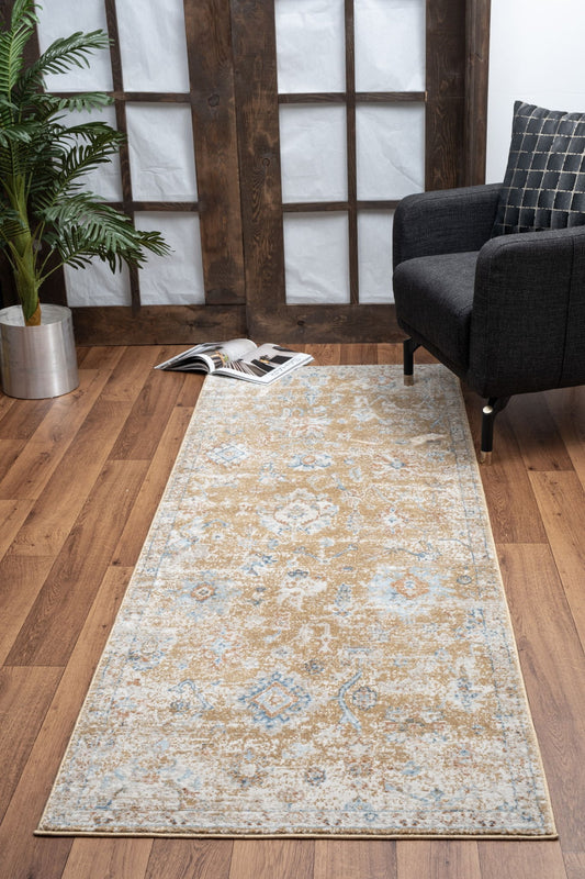 A Noble - GC_GEN7008 Area Rug with a tan and light blue pattern lies on a wooden floor beside a dark armchair, checkered pillow, open magazine, potted plant, and wooden framed windows with white paper panes.