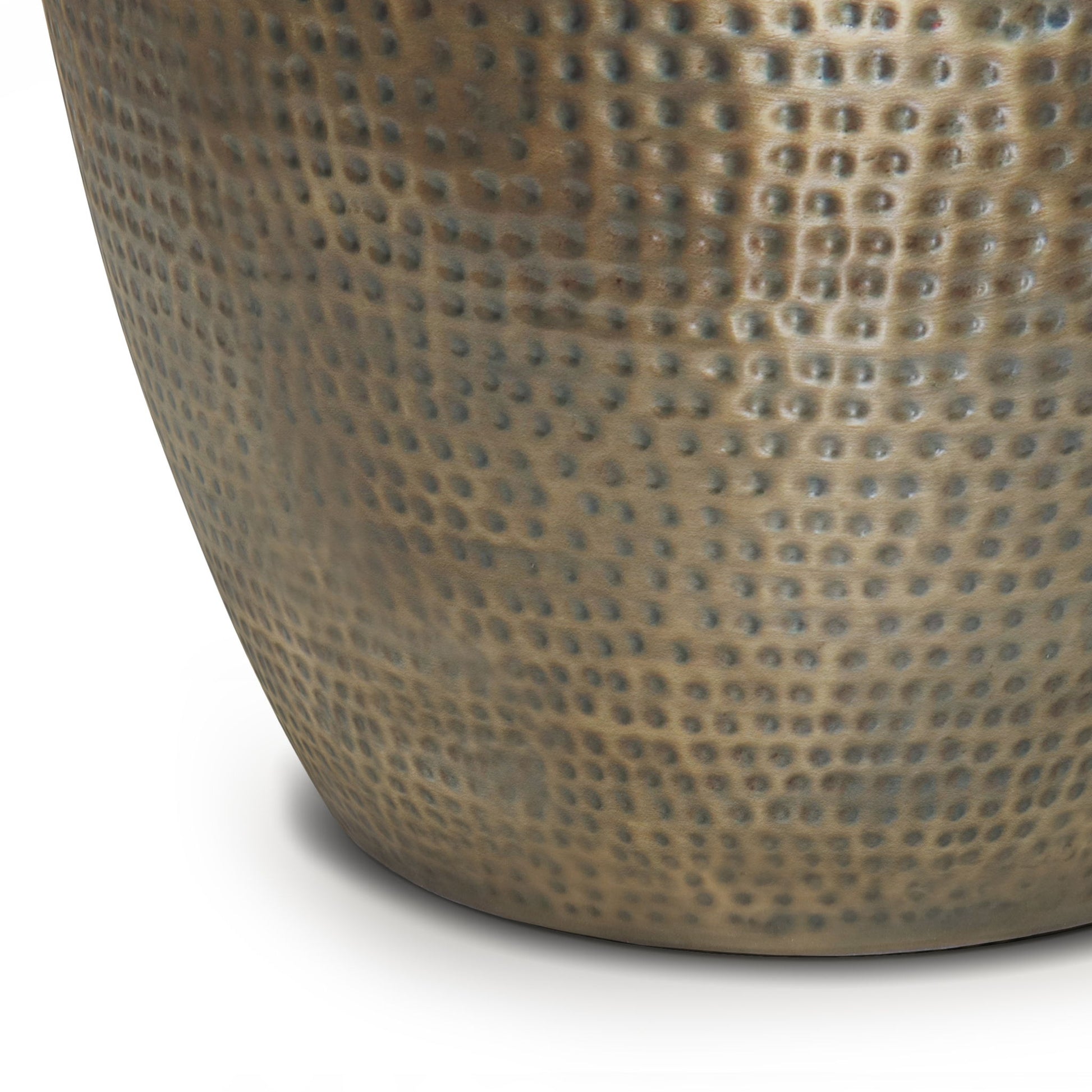 Close-up of the lower part of the Preston - Handcrafted Metal Side Table, featuring a hammered, dimpled texture and a slightly reflective bronze or brass finish, shown against a white background.