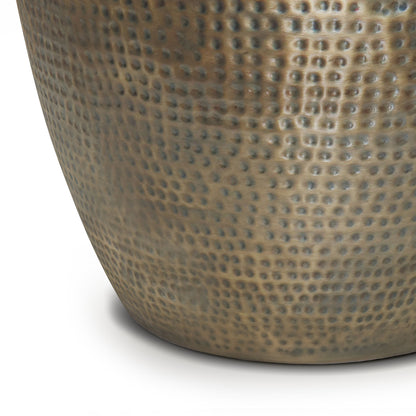 Close-up of the lower part of the Preston - Handcrafted Metal Side Table, featuring a hammered, dimpled texture and a slightly reflective bronze or brass finish, shown against a white background.