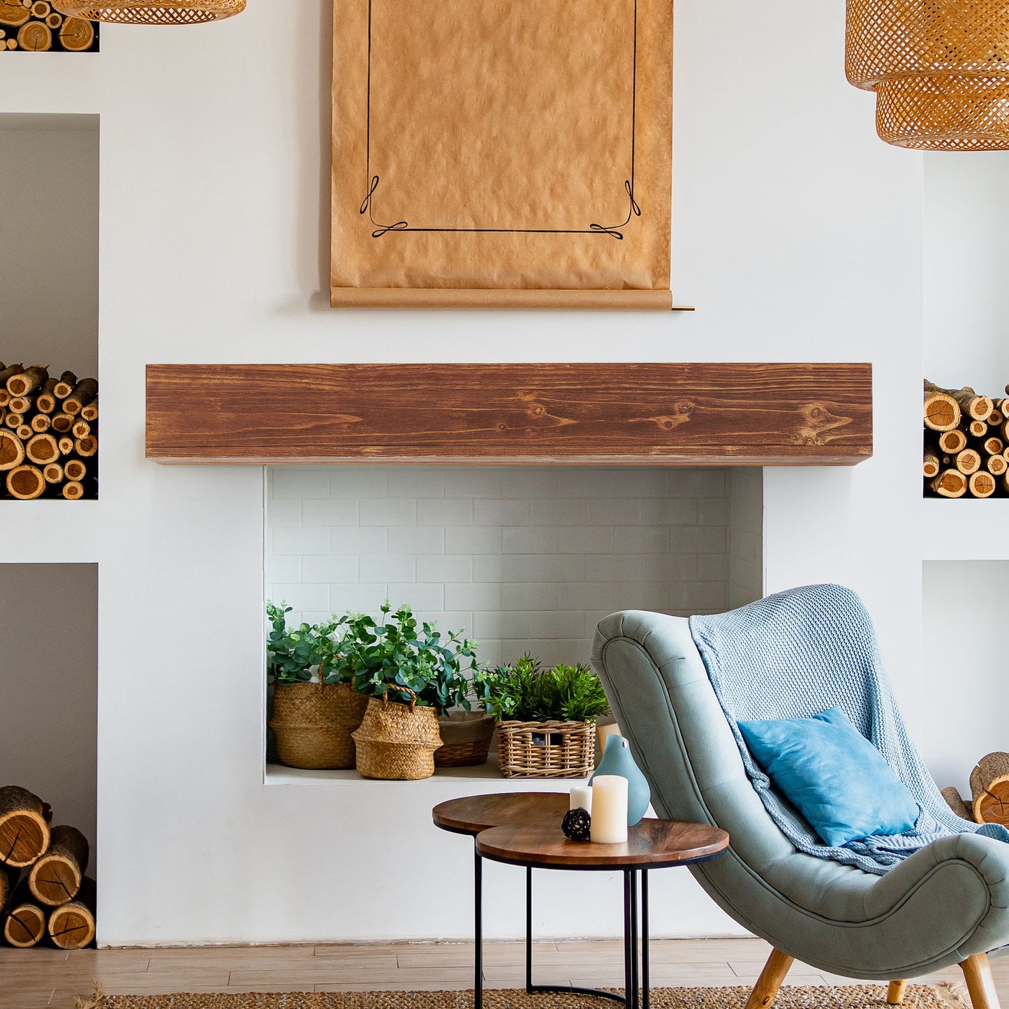 A cozy living room features a modern fireplace adorned with potted plants, a Rustic Wood Fireplace Mantel (wall-mounted, floating shelf), shelves of firewood, a blue armchair, a round wooden candle table, and a blank kraft paper scroll above.