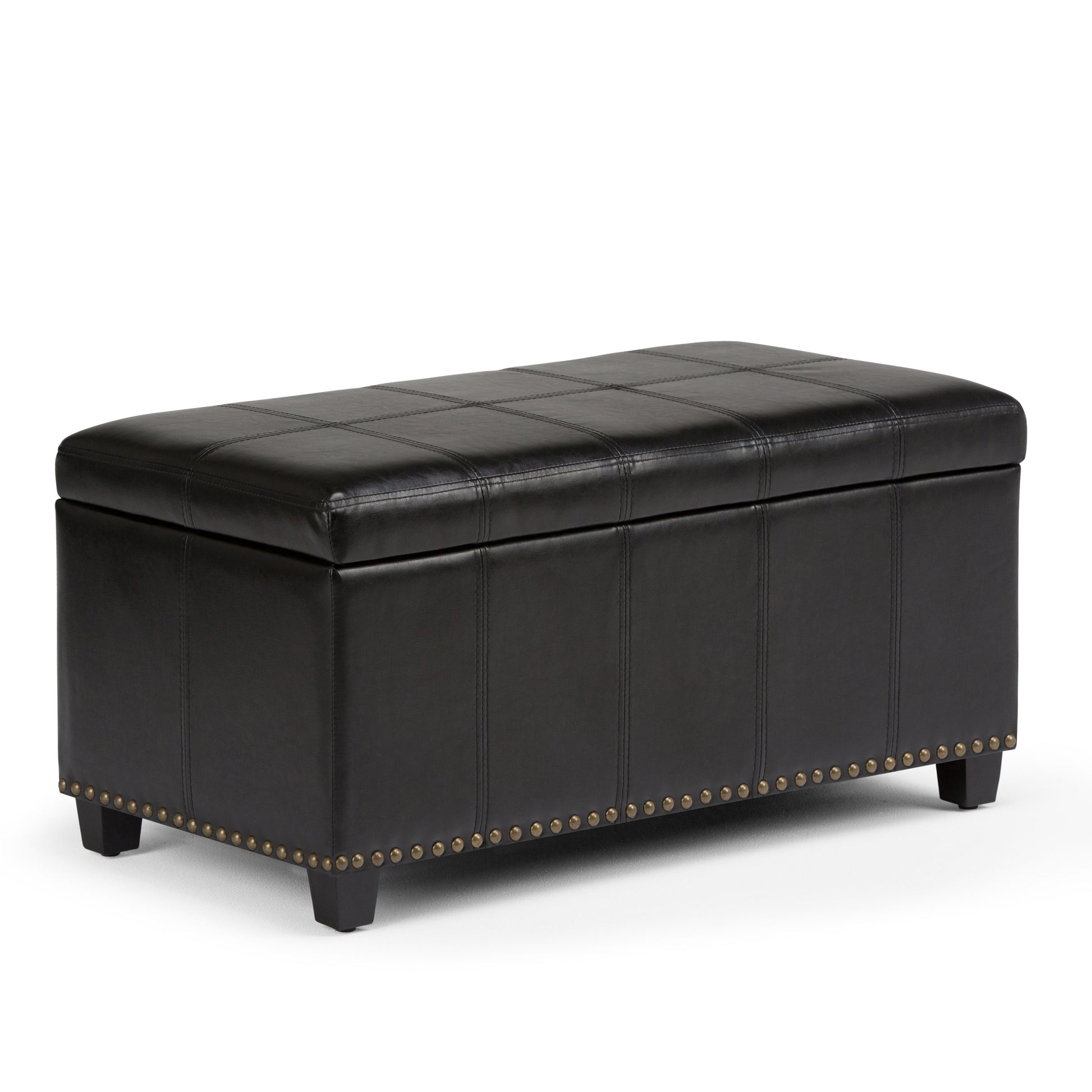 The Amelia - Transitional Storage Ottoman Bench is a rectangular black leather ottoman with stitched detailing, four short legs, and brass nailhead trim along the bottom edge.