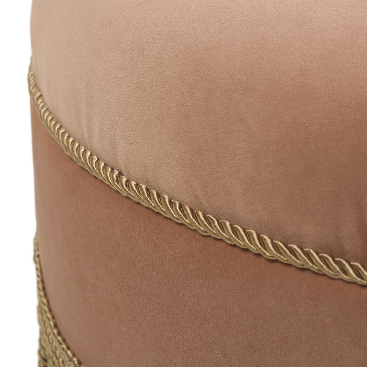 Close-up of the Yolanda Round Upholstered Accent Ottoman, featuring soft light brown velvet and two decorative gold braided cords wrapped horizontally.