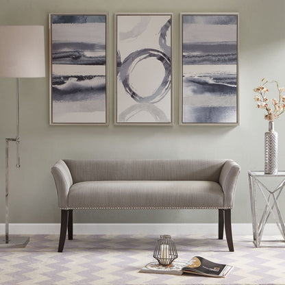 A modern living room featuring the Elegant Design Bench Upholstery with a solid wood frame, three abstract paintings, a floor lamp, glass side table with a vase, plus a magazine and candle holder on a patterned rug.