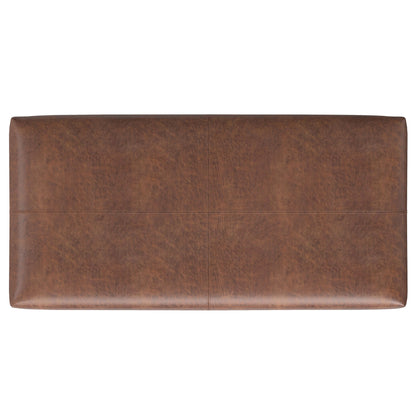 The Gabbie Coffee Table Upholstered Storage Ottoman is a rectangular brown leather piece seen from above, featuring a smooth surface with subtle stitching that divides the top into four sections.
