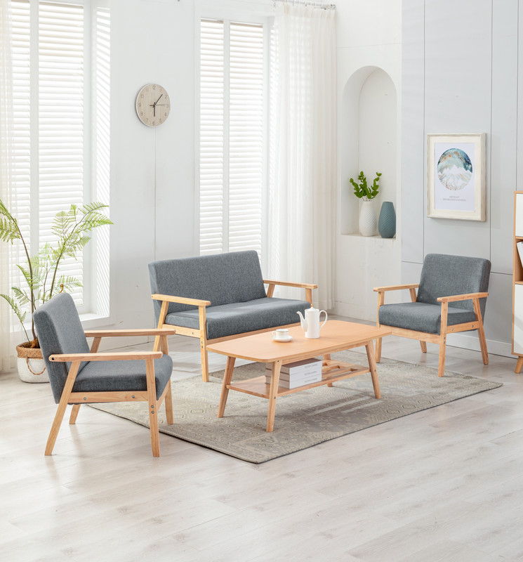 The Bahamas - Living Room Set features light wood flooring, grey armchairs and loveseat, a wooden coffee table, beige rug, potted plants, wall art, a clock, and large windows with white blinds and curtains for a modern look.