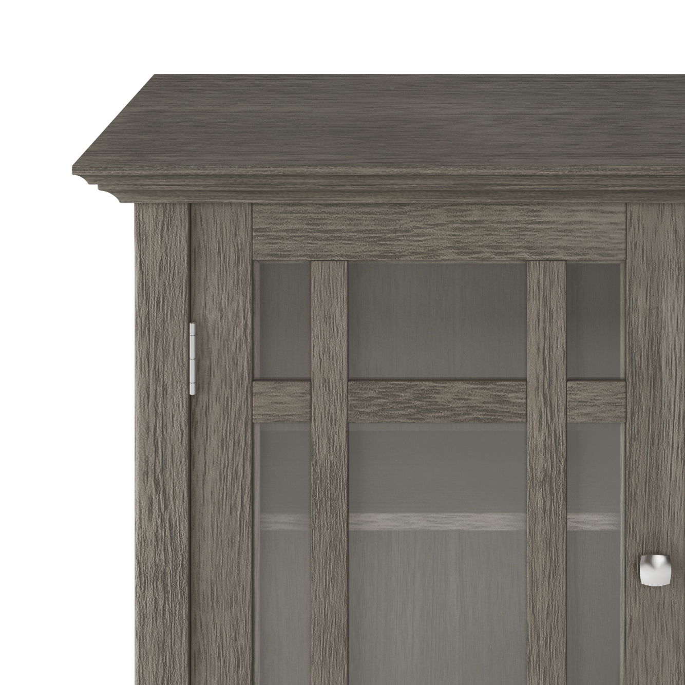 Partial view of Bedford - Storage Media Cabinet in gray wood, featuring a glass-paneled door with metal knob, modern design, visible wood grain texture, and an interior shelf.