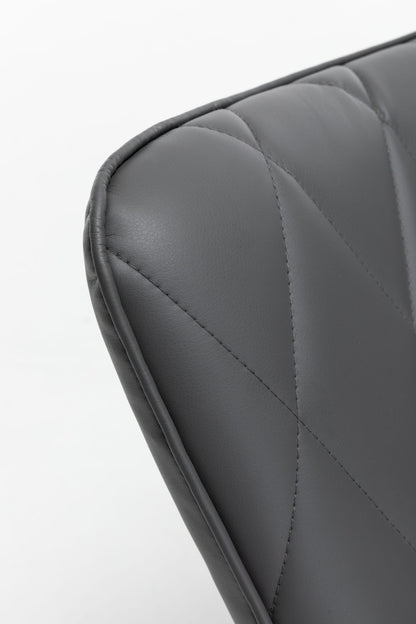Close-up of the upper corner of the Rocking Accent Chair With Lumbar Pillow And Ottoman, featuring dark gray upholstery with visible stitching and a quilted pattern on the leather surface.