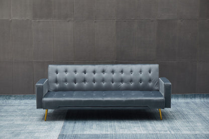 The Comfort Compact Design Sofa Bed, in modern dark gray with gold legs, is placed on a blue patterned floor before a textured dark wall.