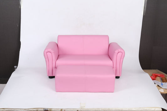 The Kids Club Chair Sofa / Sectional And Ottoman - Pink is shown in front of a plain white backdrop, with some studio equipment visible at the edges of the image.
