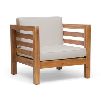 The Outdoor Acacia Wood Patio Chair With Fabric Cushion features horizontal slats on the sides and back, light beige seat and back cushions, and a modern, minimalist design. It is shown on a white background.