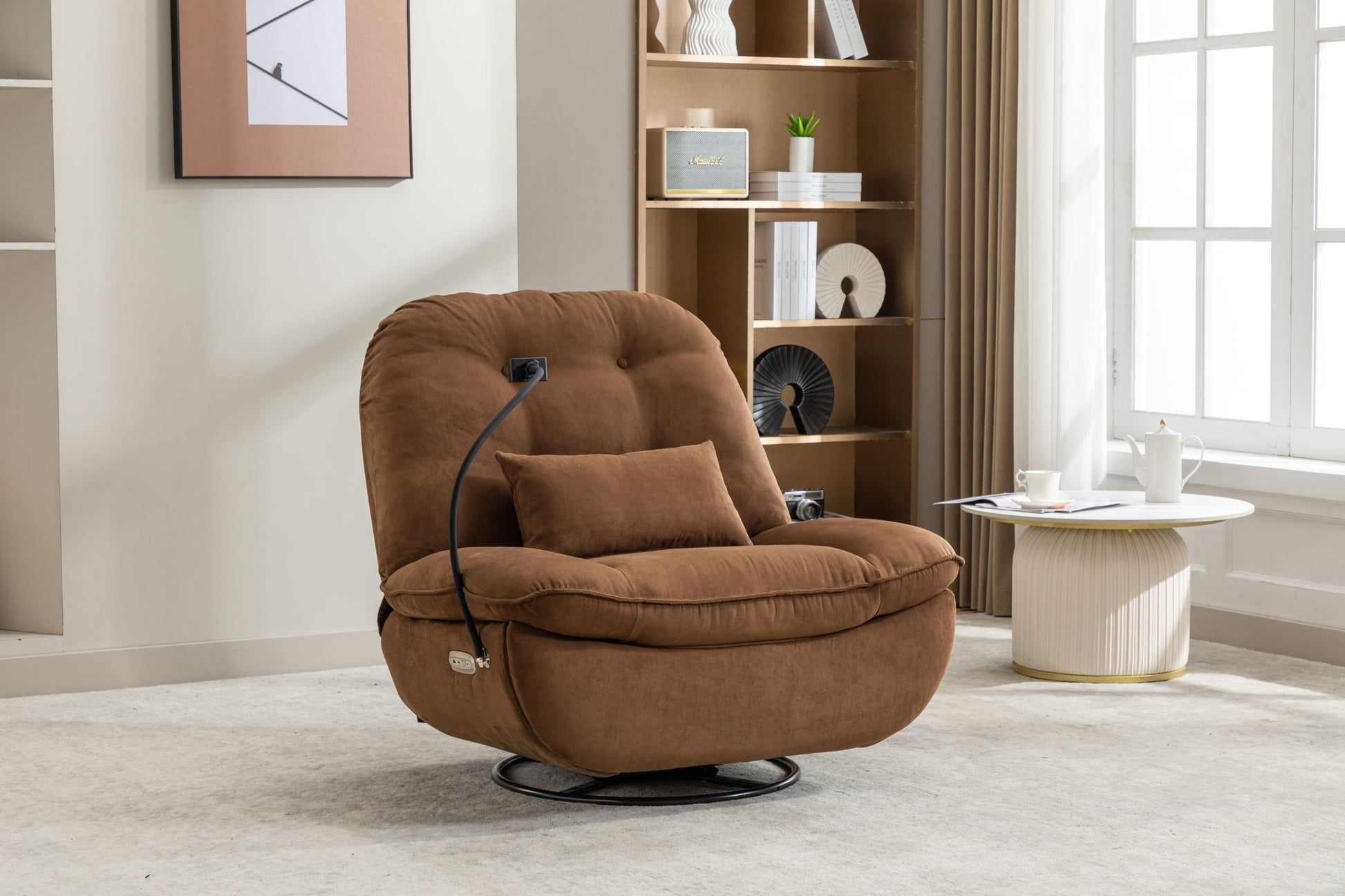 A Power Recliner Swivel Glider with USB charger and Bluetooth music player sits on a light carpet by a round white side table with teacups, in a modern living room featuring a bookshelf with decor.