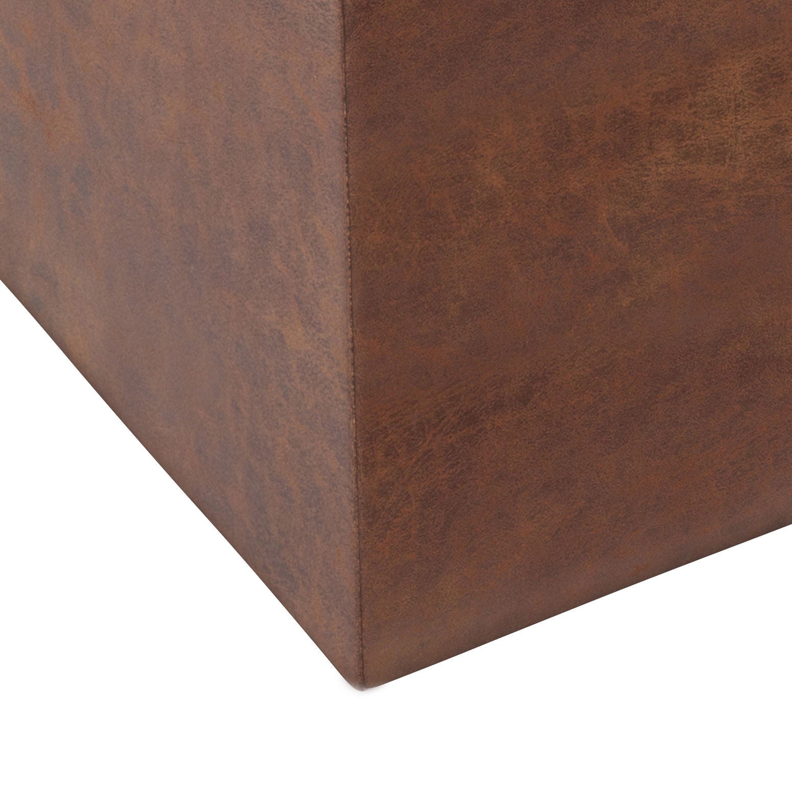 Close-up of the corner of the Rockwood Upholstered Cube Storage Ottoman With Tray in brown faux leather, highlighting its textured surface and detailed stitching.