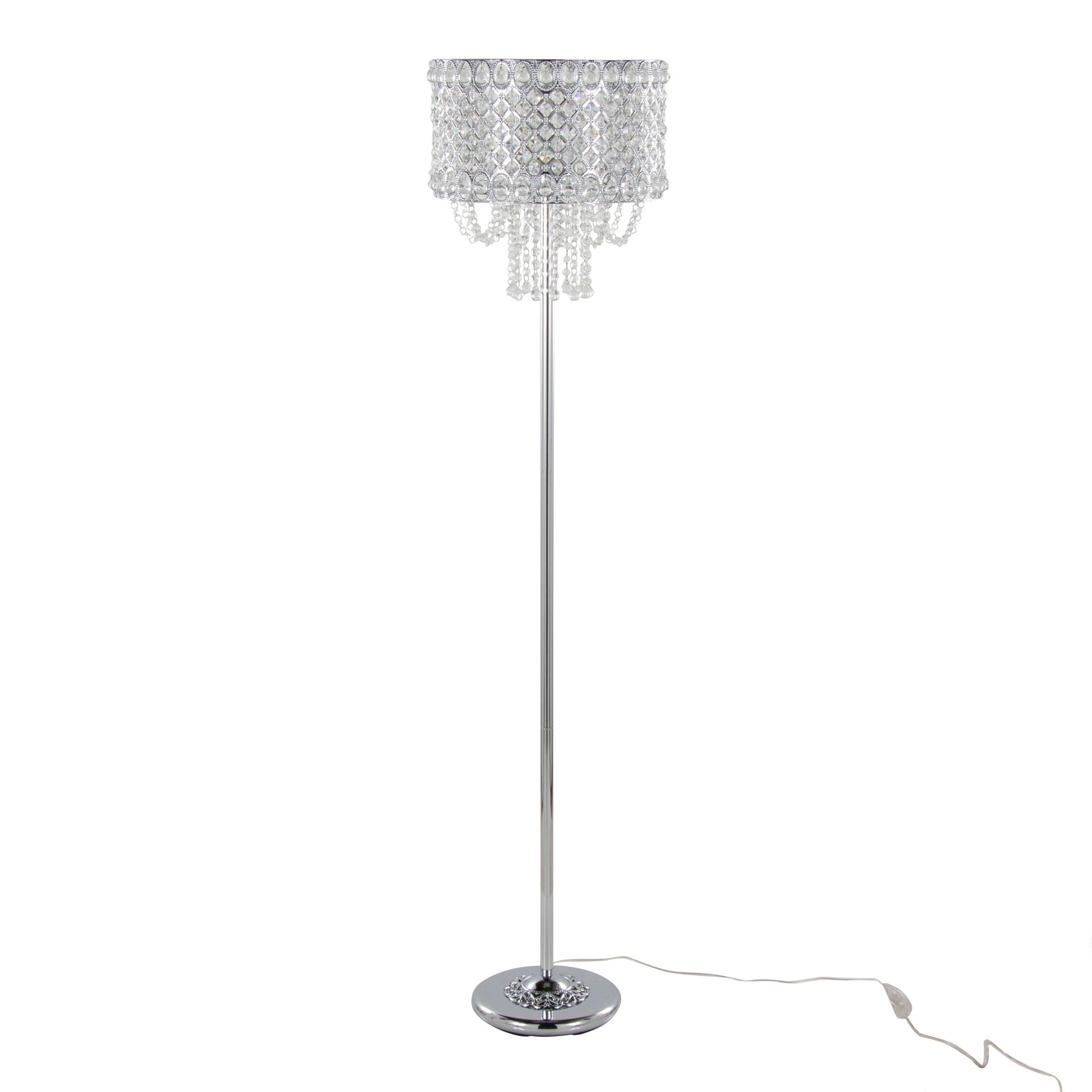 The Droplet - Contemporary Floor Lamp features a polished chrome base and stand, with a round shade adorned with clear crystal-like bead strands for a chandelier effect. An electrical cord is visible at the base.