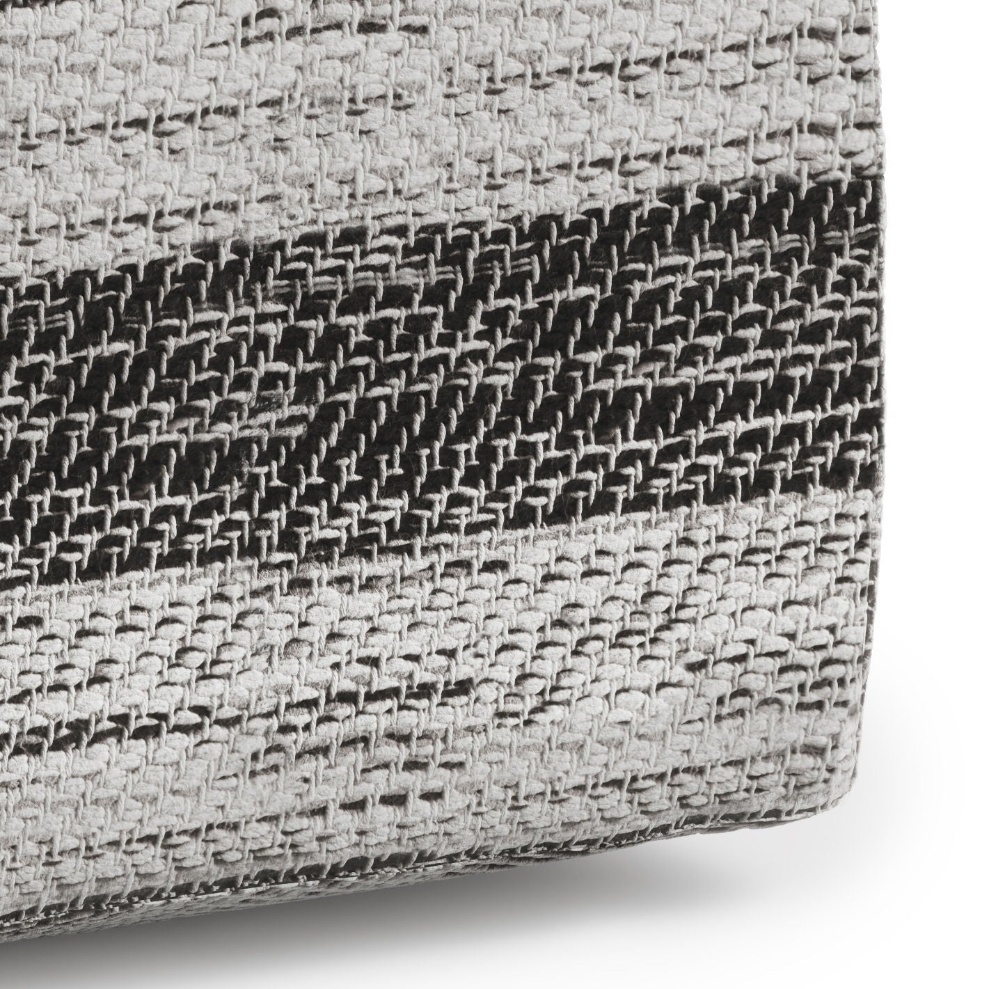 A close-up of the Clay - Square Pouf, Upholstered, showing its soft, thick woven fabric with horizontal black and gray stripes and a textured basket-weave pattern.