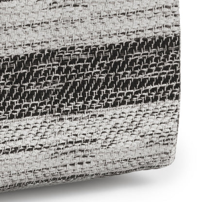 A close-up of the Clay - Square Pouf, Upholstered, showing its soft, thick woven fabric with horizontal black and gray stripes and a textured basket-weave pattern.