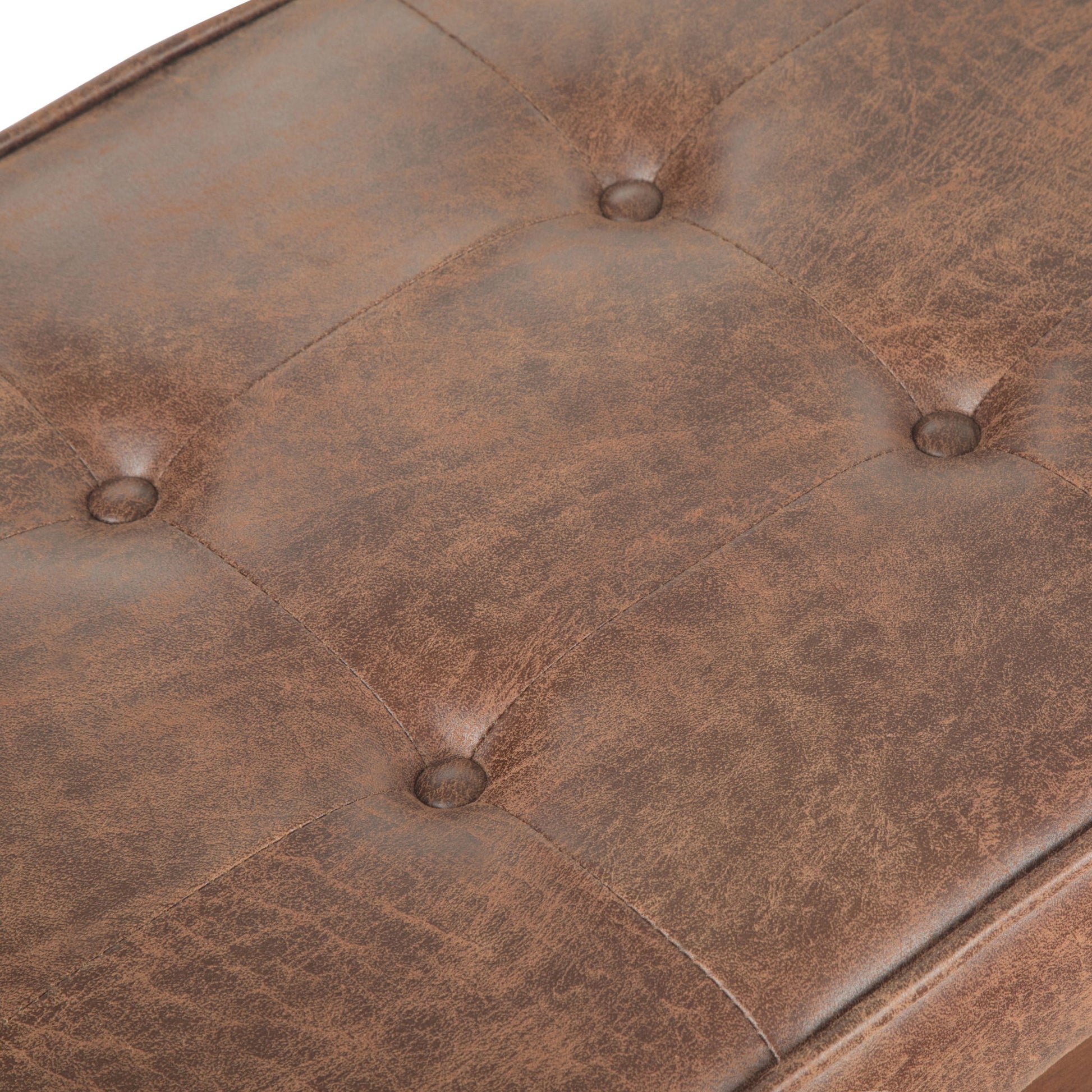 Close-up of the Pierce - Mid Century Upholstered Ottoman Bench, featuring a brown tufted leather cushion with visible stitching and four buttons in a square pattern. The leather has a slightly distressed, vintage appearance.