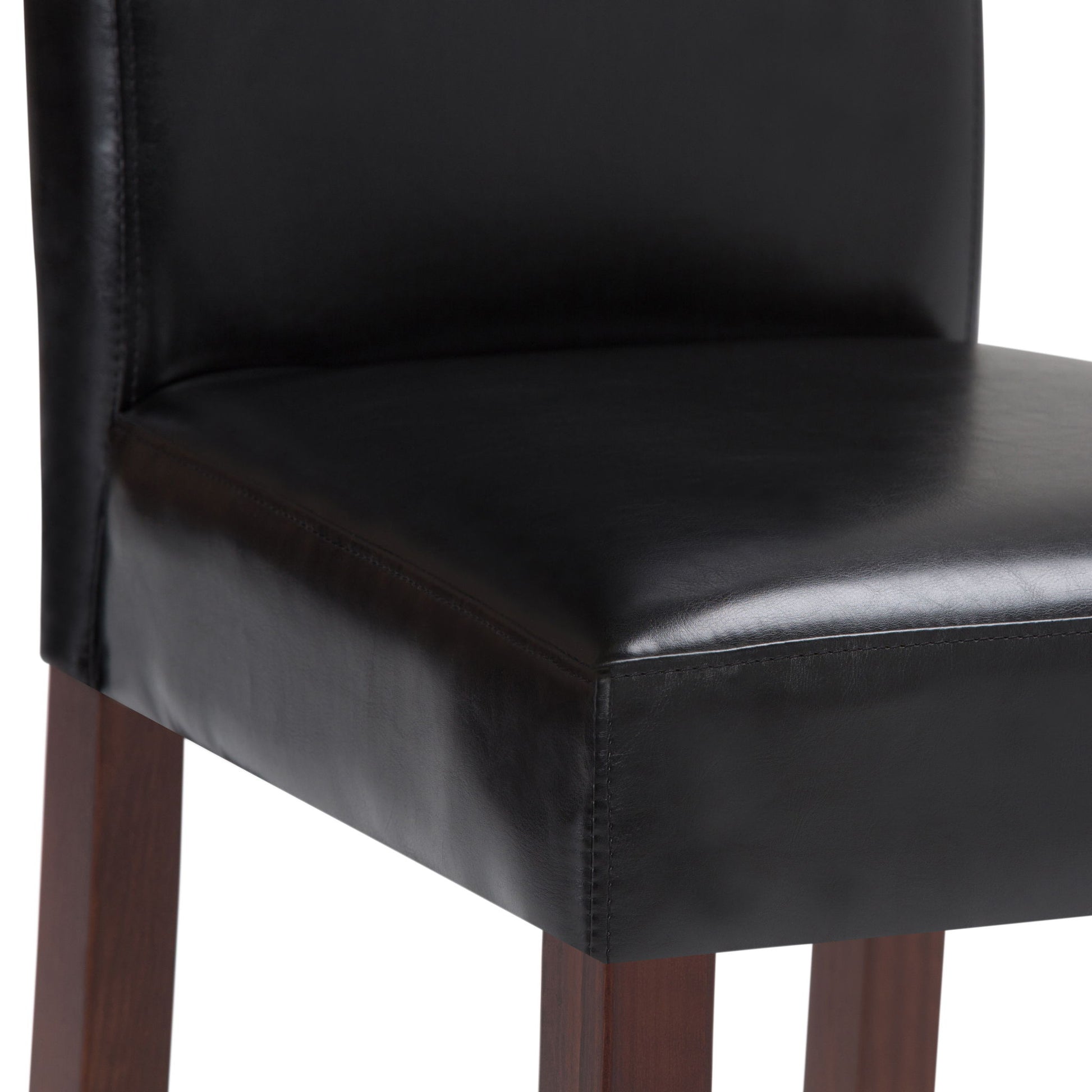 A close-up of the Acadian - Upholstered Parson Dining Chair (Set of 2), showcasing its black leather seat and backrest with dark wooden legs.