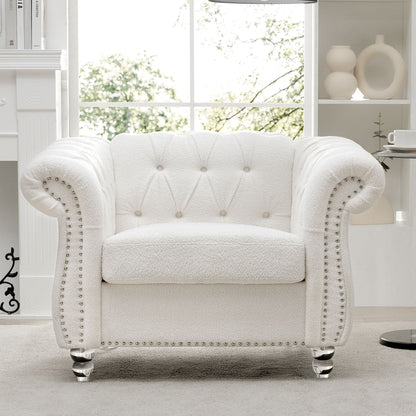 A 1 Seater Sofa For Living Room with white tufted upholstery, rolled arms, and silver nailhead trim is placed in a bright modern space featuring a large window and neutral decor.