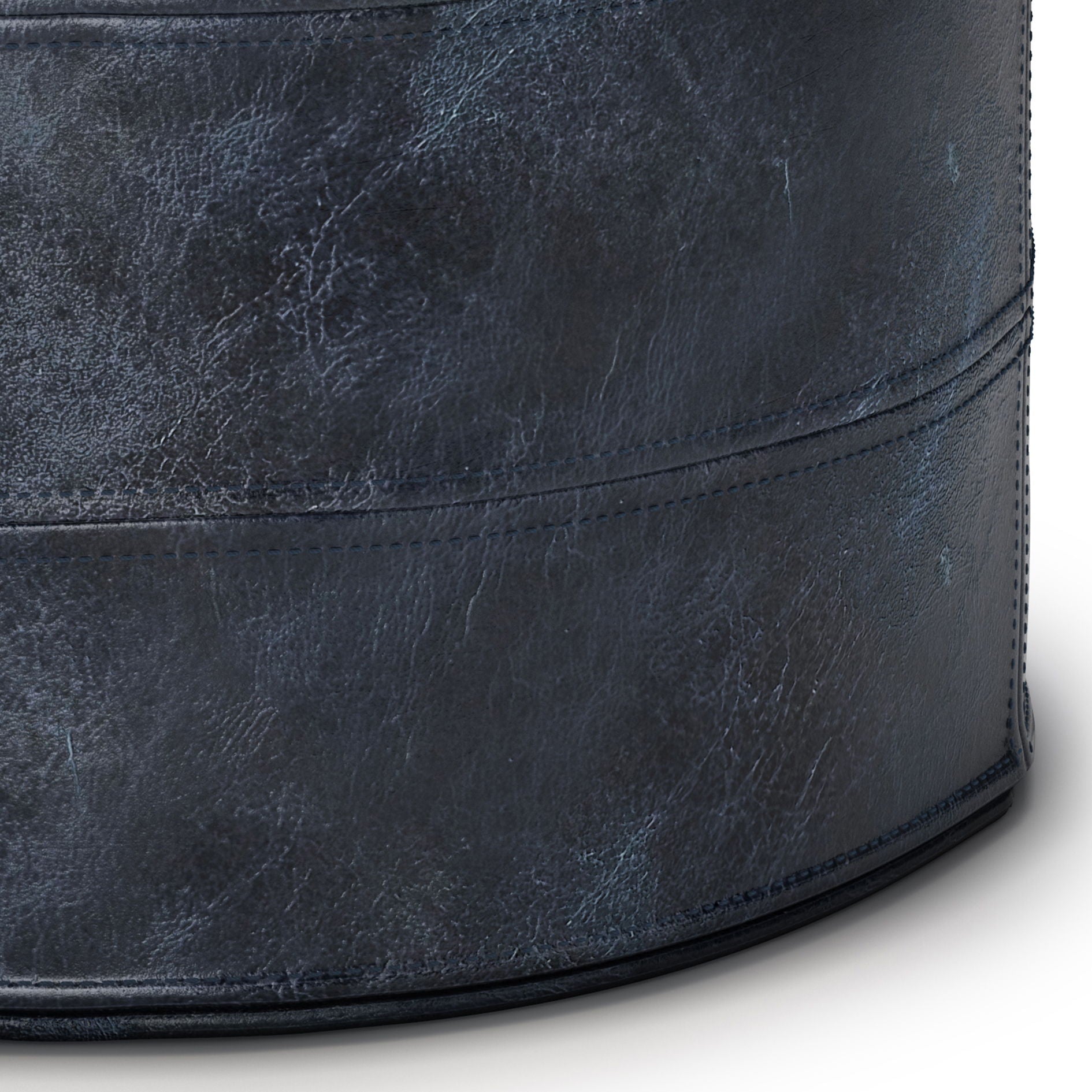 Close-up of the Connor - Handcrafted Round Pouf in dark blue, showcasing its textured, cylindrical form with visible stitching and a leather-like finish.