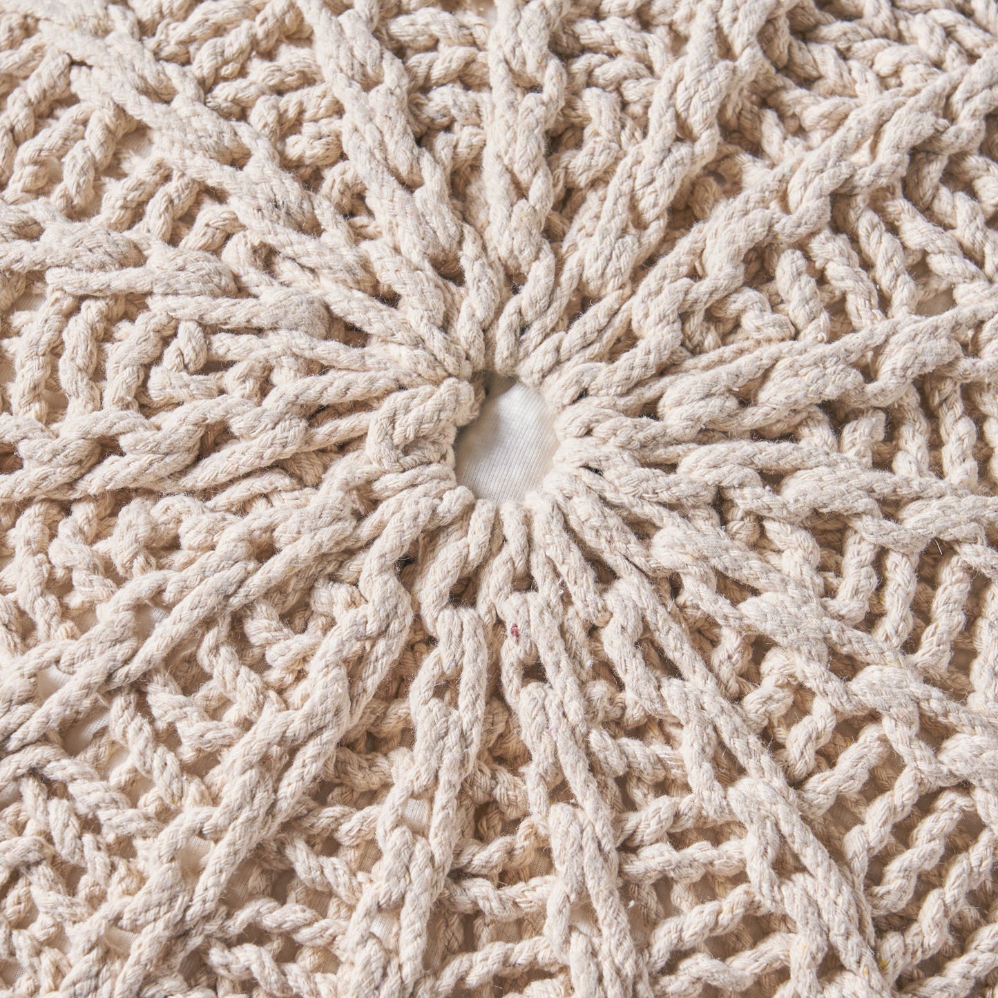 Close-up of the Bordeaux - Knitted Cotton Round Pouf Ottoman and Floor Cushion, featuring a cream-colored, circular crochet pattern with a white fabric center and radiating textured loops and knots.