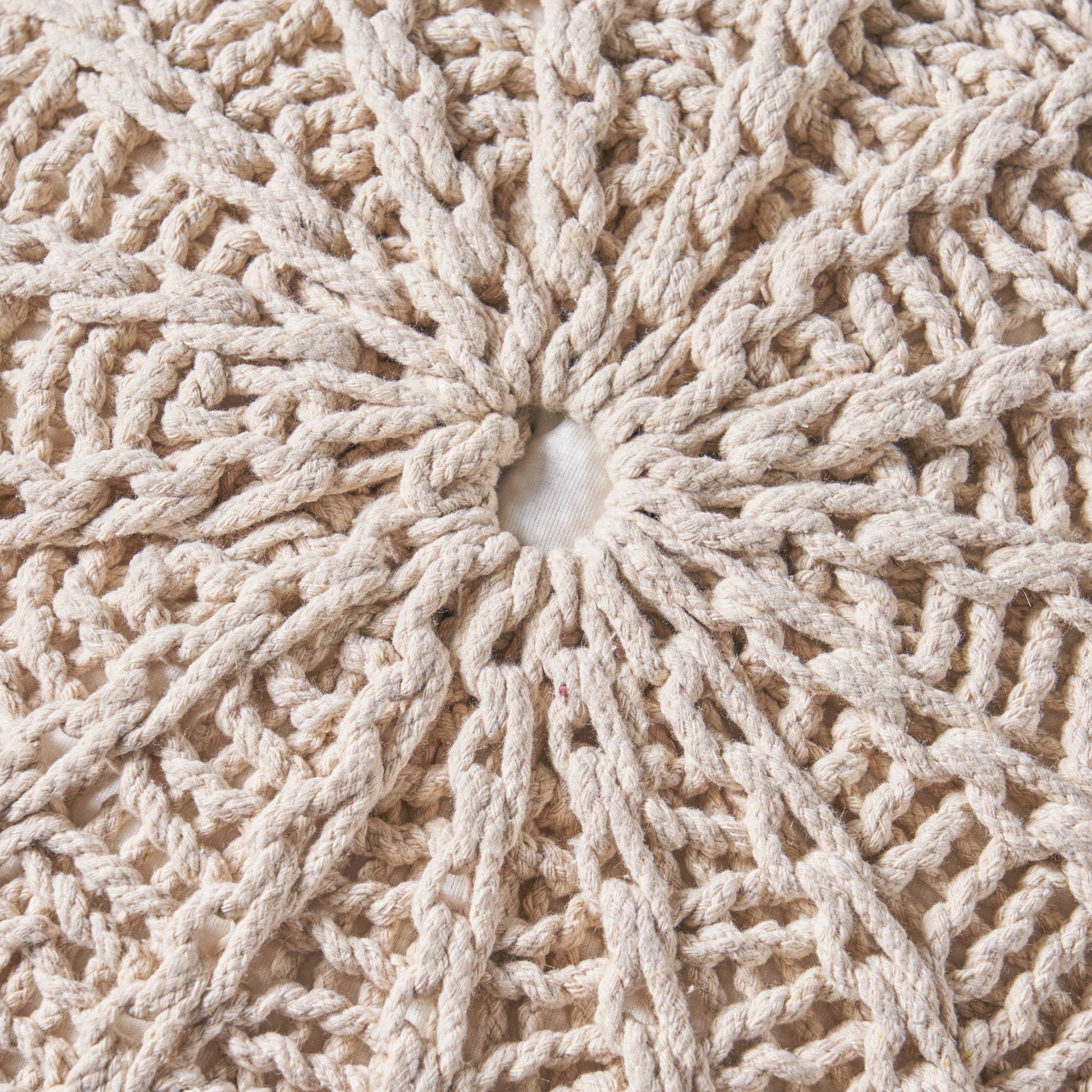 Close-up of the Bordeaux - Knitted Cotton Round Pouf Ottoman and Floor Cushion, featuring a cream-colored, circular crochet pattern with a white fabric center and radiating textured loops and knots.