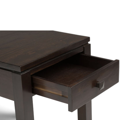 The Cosmopolitan Multipurpose Table features a dark wood finish, a rectangular top, and a single drawer with a square metal knob, perfect for storing essentials.