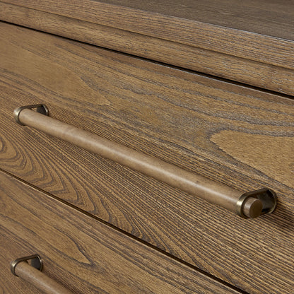 Close-up of the Metal Base Sideboard - Light Brown, showing its natural grain wood finish and a horizontal cylindrical metal handle with bronze accents. Two drawers are partially visible in the image.
