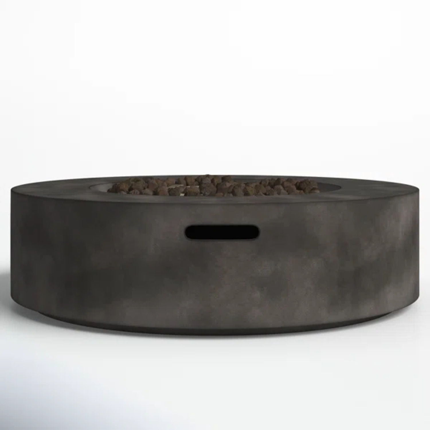 The Fiber Reinforced Outdoor Fire Pit Table in black/gray is a modern round fire pit made of smooth concrete, featuring a central area with small rocks and a rectangular cutout on the side.