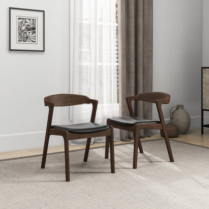 Two Dakota Mid-Century Modern Velvet Dining Chairs (set of 2) with black seats are arranged on a light rug in a minimalist room featuring a large window, gray curtains, framed wall art, and ceramic vases in the corner.