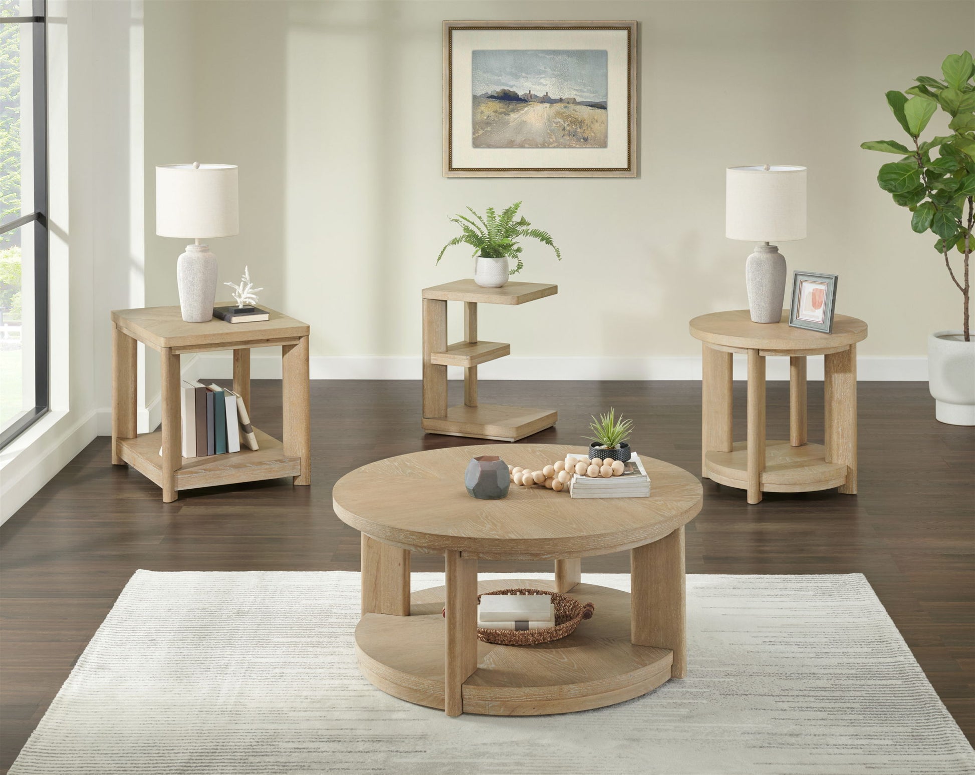 A bright living room features the Clove Chairside Table in tan, a light rug, table lamps, books, plants, and a framed landscape painting. A large window and green potted plant complete the modern decor.