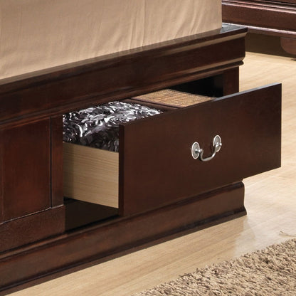 A close-up of the Louis Phillipe - Bookcase Storage Bed shows its dark wood frame with an open underbed drawer, a mattress topped with a floral cover, light wooden flooring, and part of a textured beige rug in view.