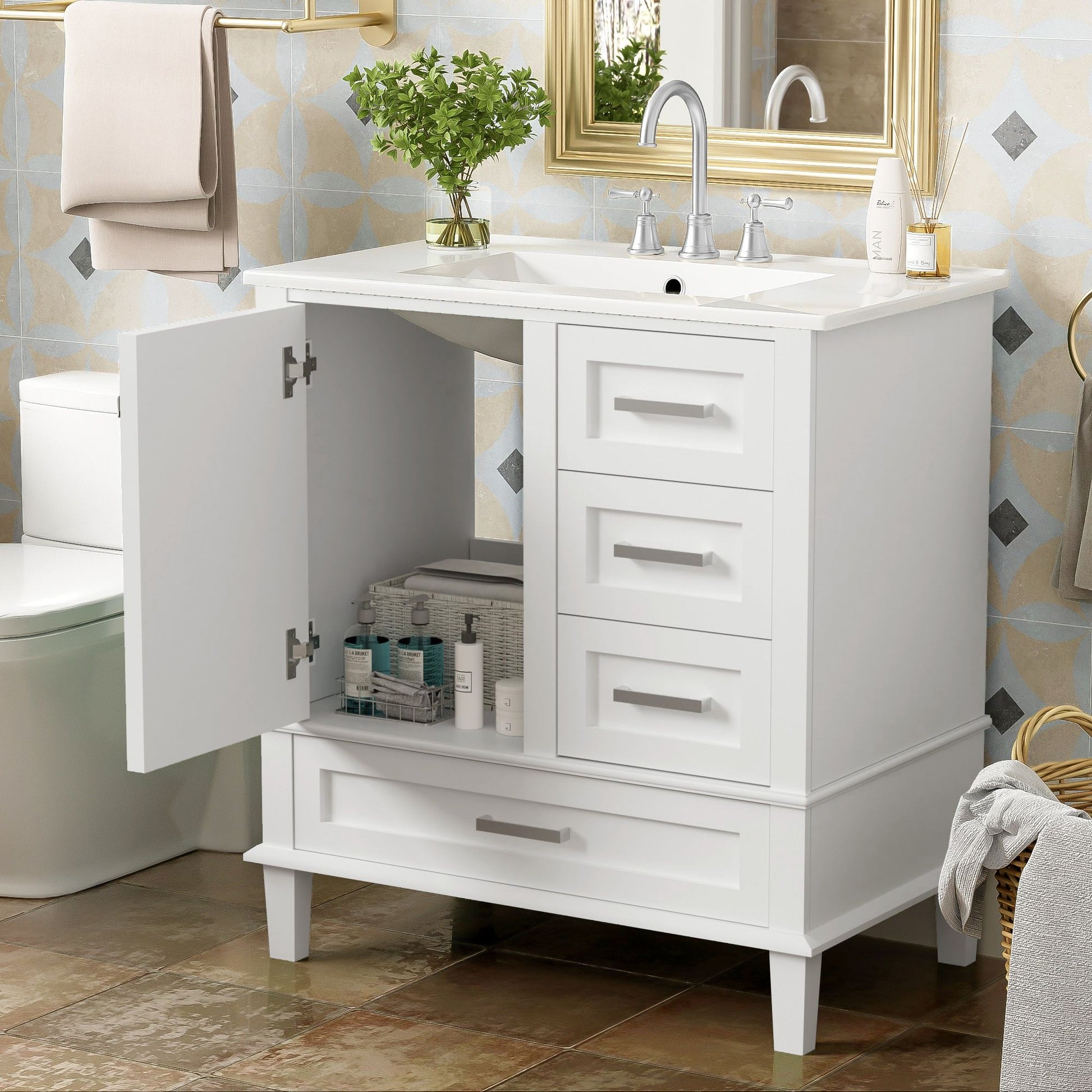 A modern bathroom vanity with a solid wood frame features a sink, chrome faucet, plant on top, soft closing door open to reveal organized toiletries, and 3 drawers. A mirror and towel are visible in the background.