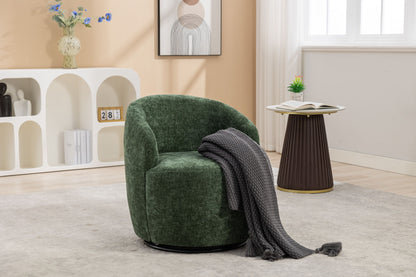 A Chenille Fabric Swivel Accent Armchair Barrel Chair with a dark gray knit throw sits on a light rug; nearby, a round side table holds a plant and open book. In the background are a white shelf, artwork, and vase.