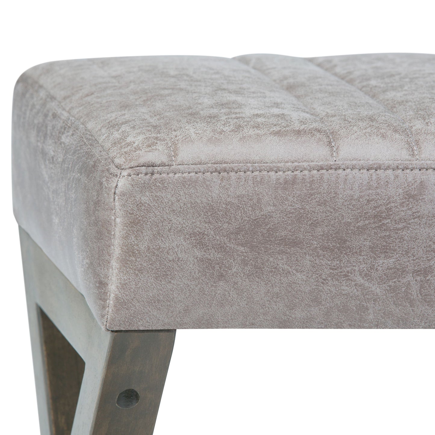 Close-up of the Salinger - Large Upholstered Ottoman Bench, showcasing its soft light gray velvet cushion and angular wooden leg. Fabric texture and detailed stitching are clearly visible.