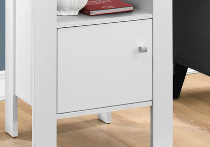 The Accent Nightstands, Storage, And Transitional features a white cabinet with a square handle, an open shelf displaying a red book and white vase, and stands on a light wood floor.