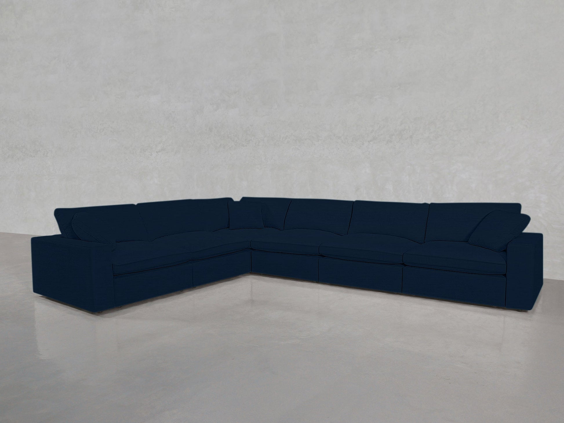 A 6-Seat Modular Corner Sectional in dark blue sits on a shiny light gray floor against a plain light-colored wall.