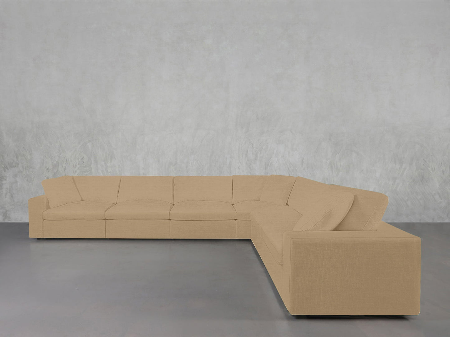 A 6-Seat Modular Corner Sectional with simple, clean lines in beige rests on a gray concrete floor against a light textured wall.