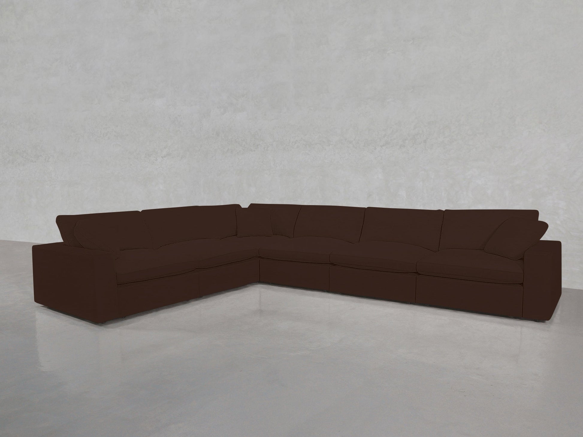 A 6-Seat Modular Corner Sectional in dark brown is placed on a shiny, light gray floor against a plain, light gray wall.