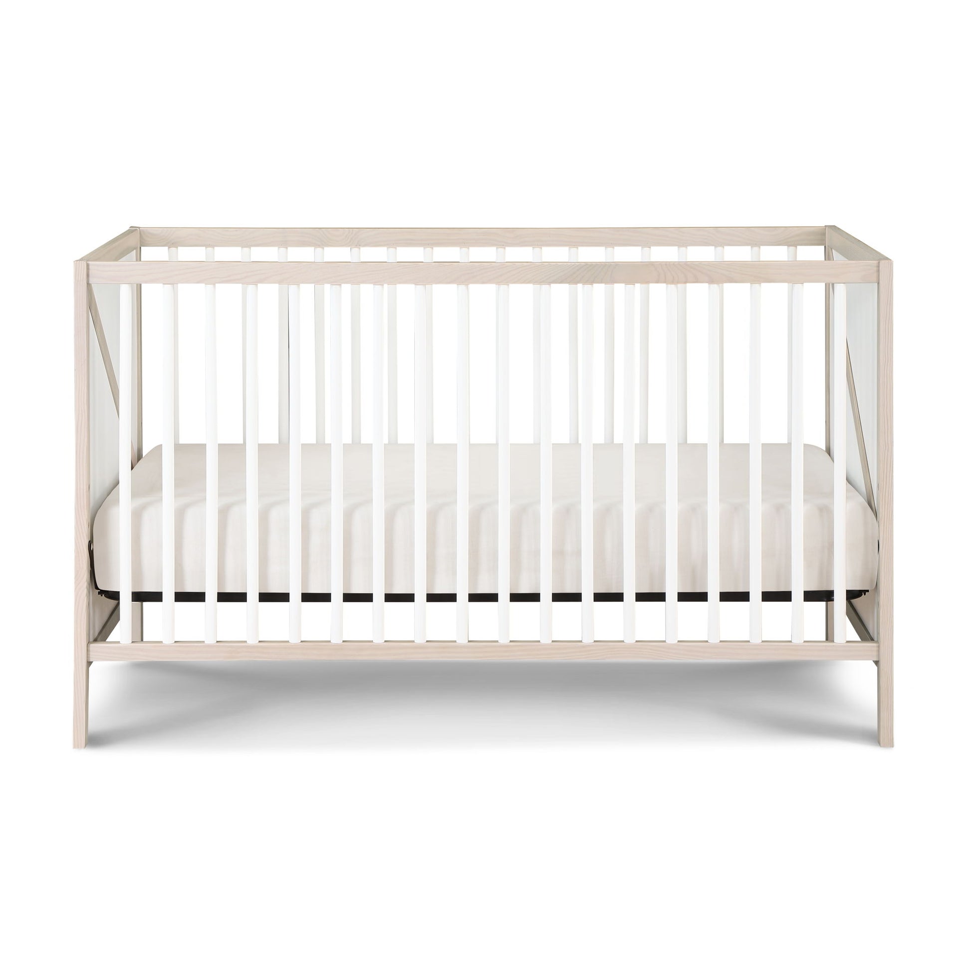 The Pixie Zen 3-in-1 Crib in Walnut, featuring white slats and a matching white mattress, is displayed against a plain white background.