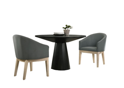 The Jasper - 47" Round Dining Table Set features a round black pedestal table, two gray upholstered chairs with light wooden legs, plus a small plant and dishes on the table, all shown against a white background.