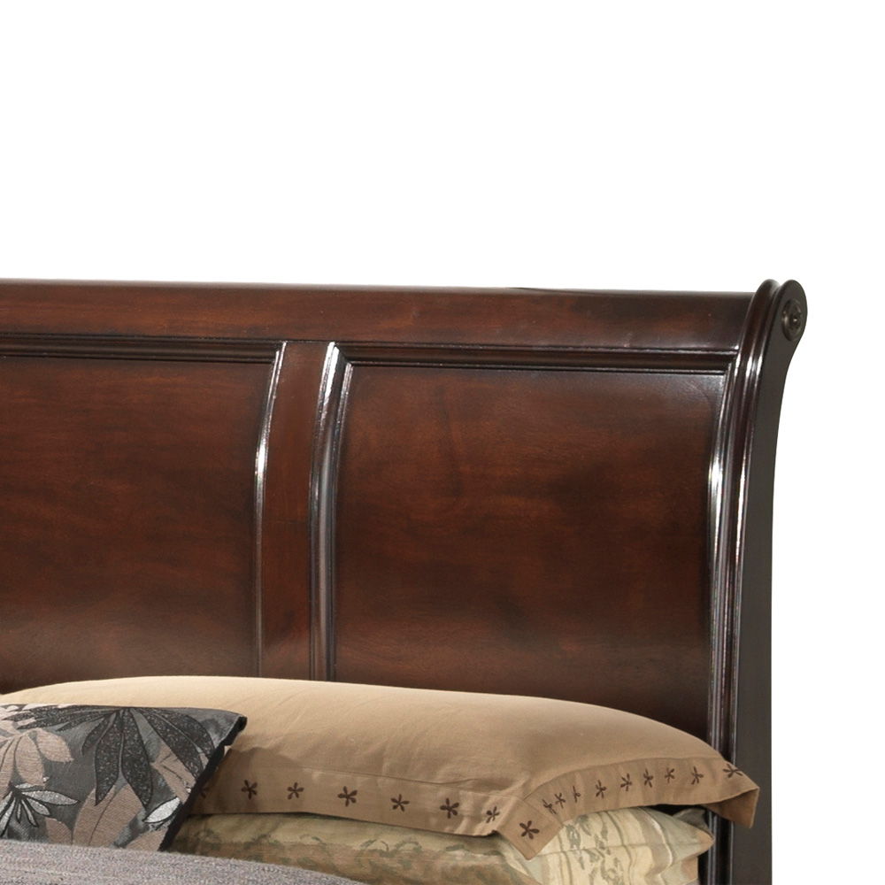 A close-up of the LaVita - Storage Bed's dark wood sleigh headboard with a glossy finish. Beige pillows featuring leaf and star patterns appear at the bottom of the image.