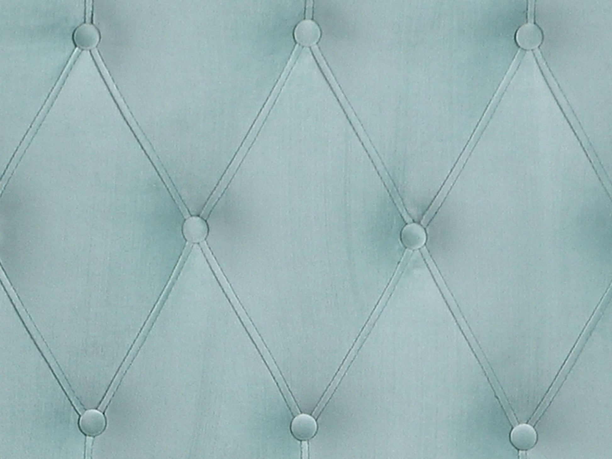 Close-up of the Luma Upholstered Bed's light blue tufted fabric, featuring diamond-shaped stitching and buttons at each intersection for a quilted, padded texture.