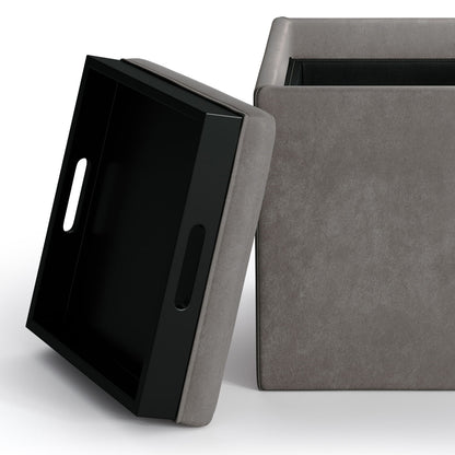 The Rockwood Upholstered Cube Storage Ottoman features a removable lid that doubles as a black tray with handles for easy carrying.