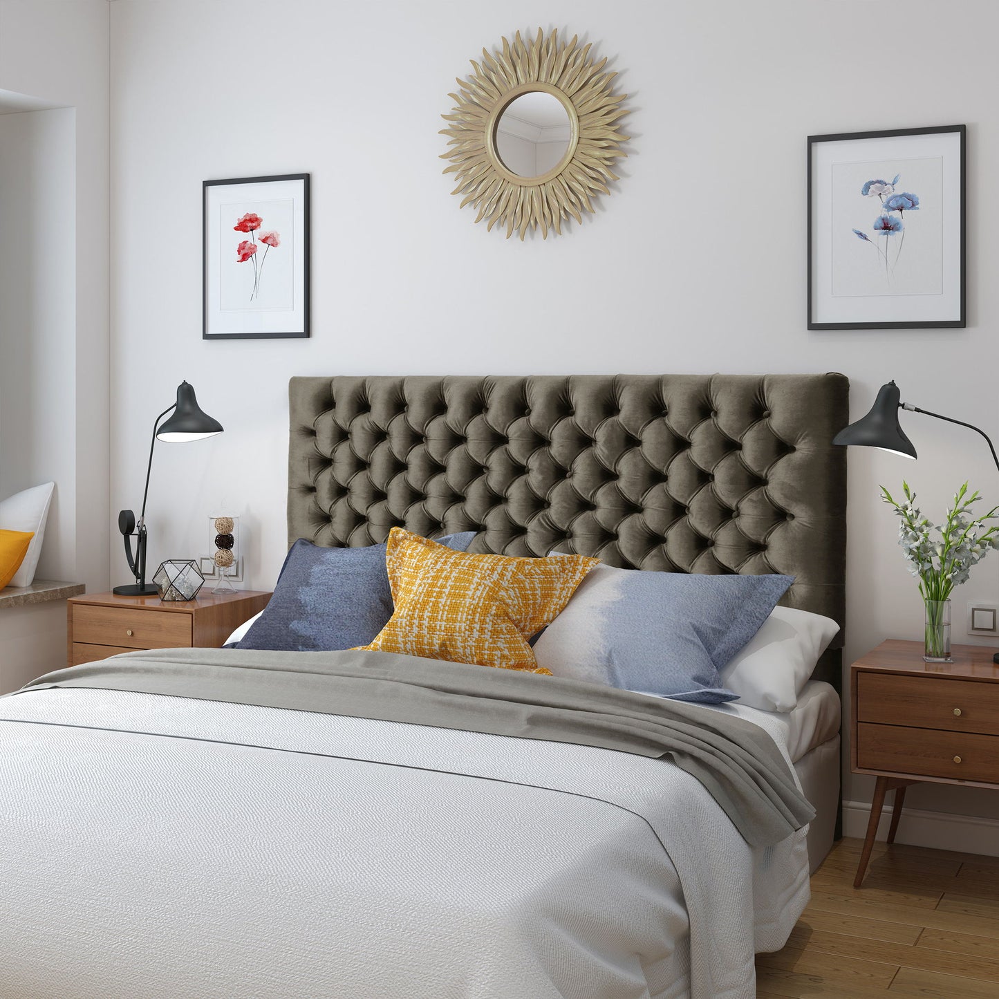 A modern bedroom featuring the Annecy Contemporary Upholstered Headboard, a double bed with white and gray bedding, blue and yellow accent pillows, mid-century nightstands, wall art, adjustable lamps, and a round sunburst mirror above the bed.