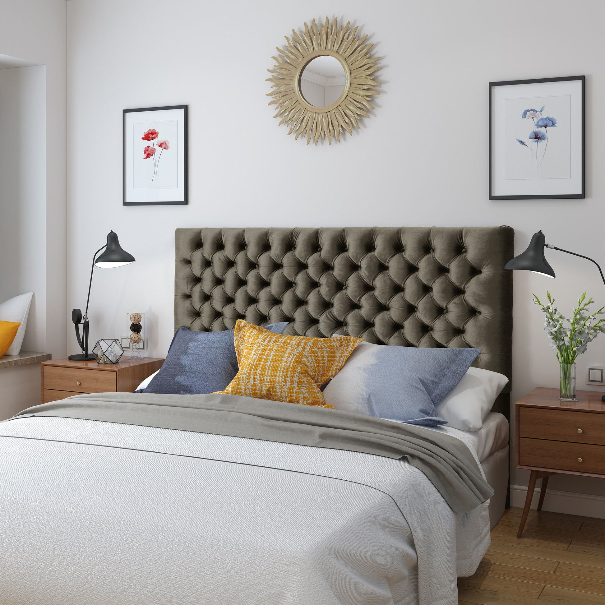 A modern bedroom featuring the Annecy Contemporary Upholstered Headboard, a double bed with white and gray bedding, blue and yellow accent pillows, mid-century nightstands, wall art, adjustable lamps, and a round sunburst mirror above the bed.