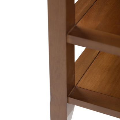 Close-up of the Acadian - Handcrafted End Table corner, featuring brown wood grain, two shelves, and part of the supporting frame against a white background.