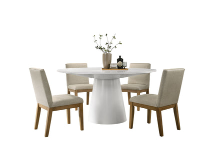 The Jasper Wide Contemporary Round Dining Table Set features a modern white table and four beige upholstered chairs with wooden legs, accented by a vase with branches and two small decorative objects on the tabletop.